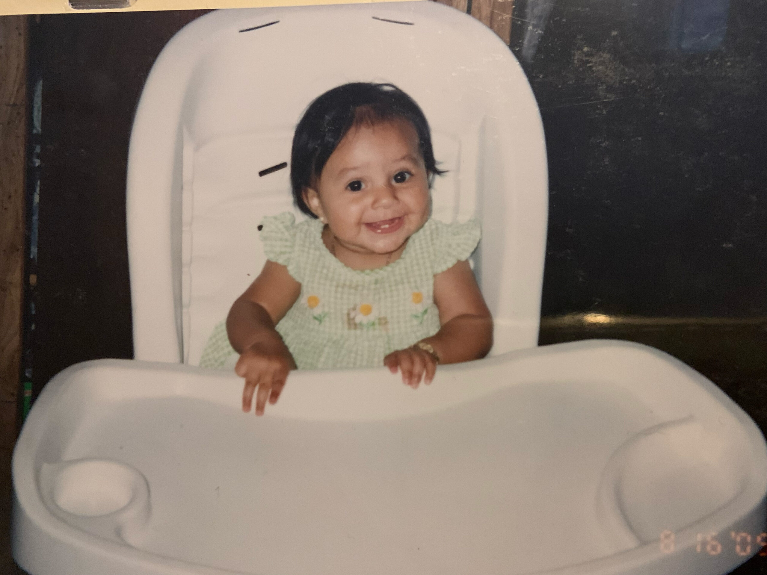 a young child sitting in a high chair.