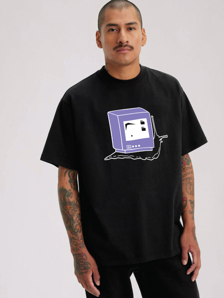 A man is modeling a black t-shirt with the old computer snail printed on it.