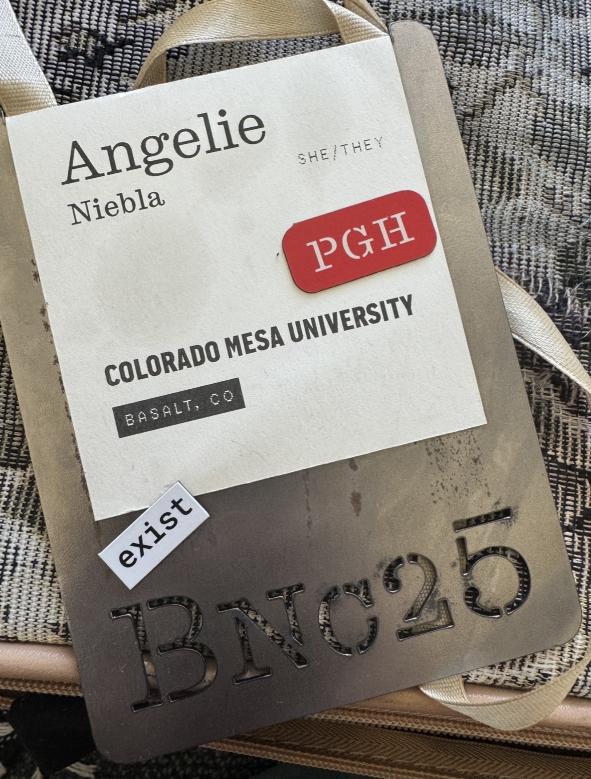 metal name tag for graphic design conference with magnets on it